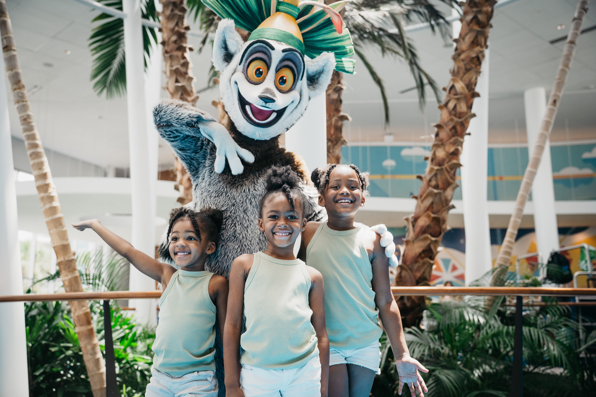 Roberson kids posing with a resort mascot character inside the Cabana Bay Beach Resort lobby