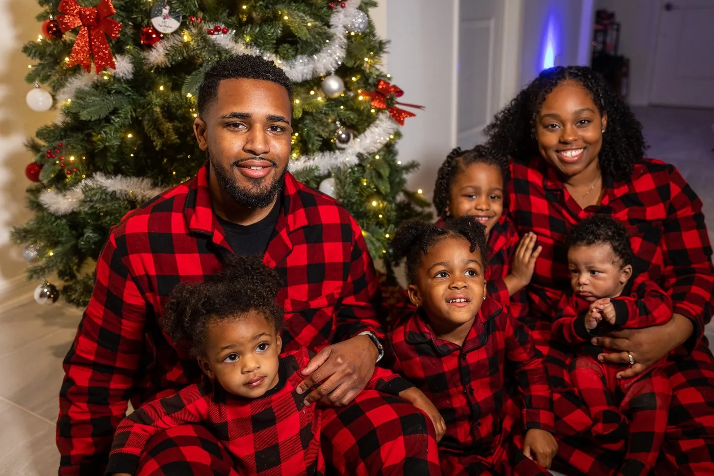The Roberson family in matching red buffalo plaid pajamas together at Christmas before the YouTube channel existed