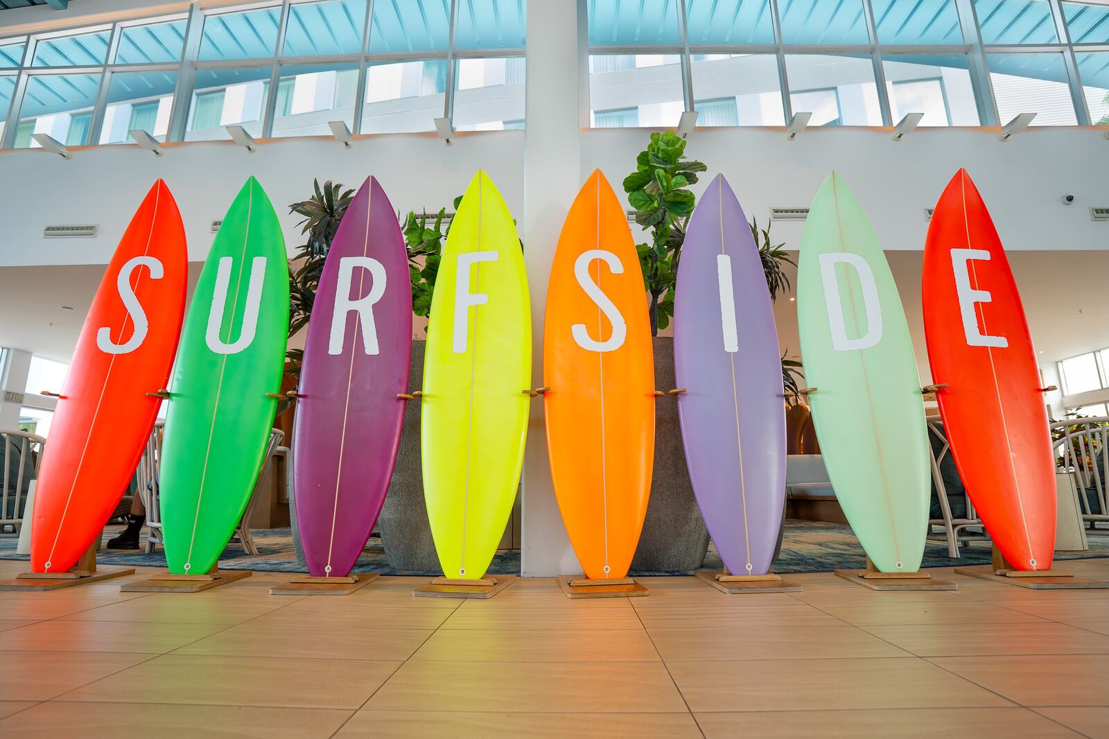 A row of colorful surfboards spelling out Surfside inside the lobby at Universal's Endless Summer Resort