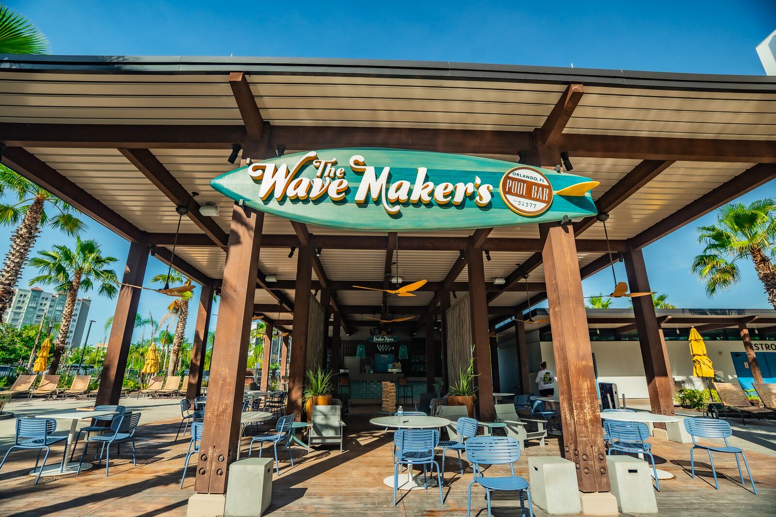 Wave Maker's pool bar at Universal's Endless Summer Resort Dockside with palm trees and lounge seating
