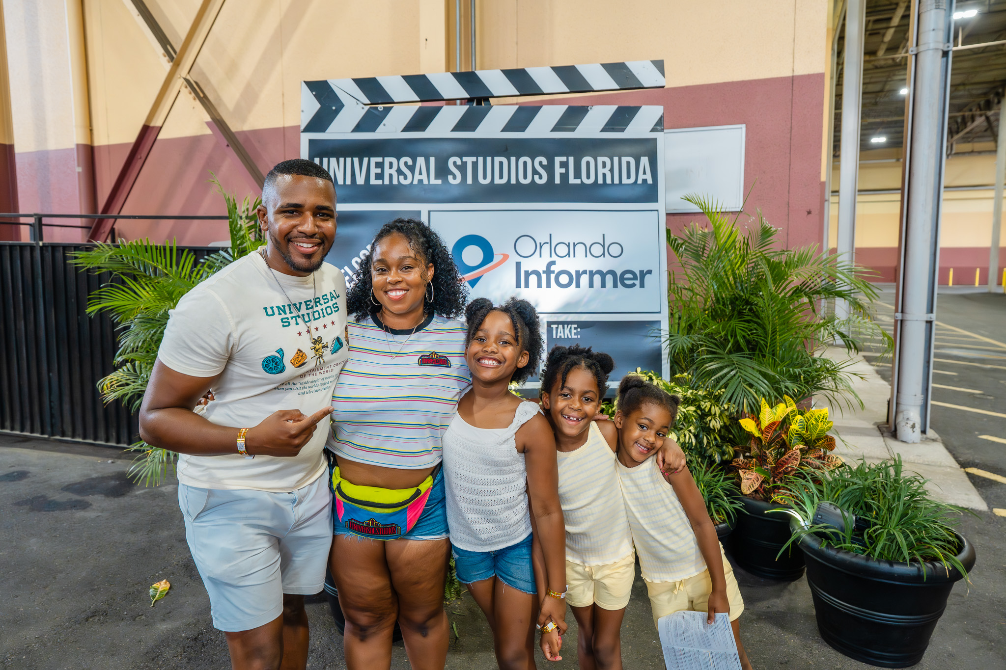 The Roberson family posing at the Orlando Informer check-in sign at Universal Studios Florida