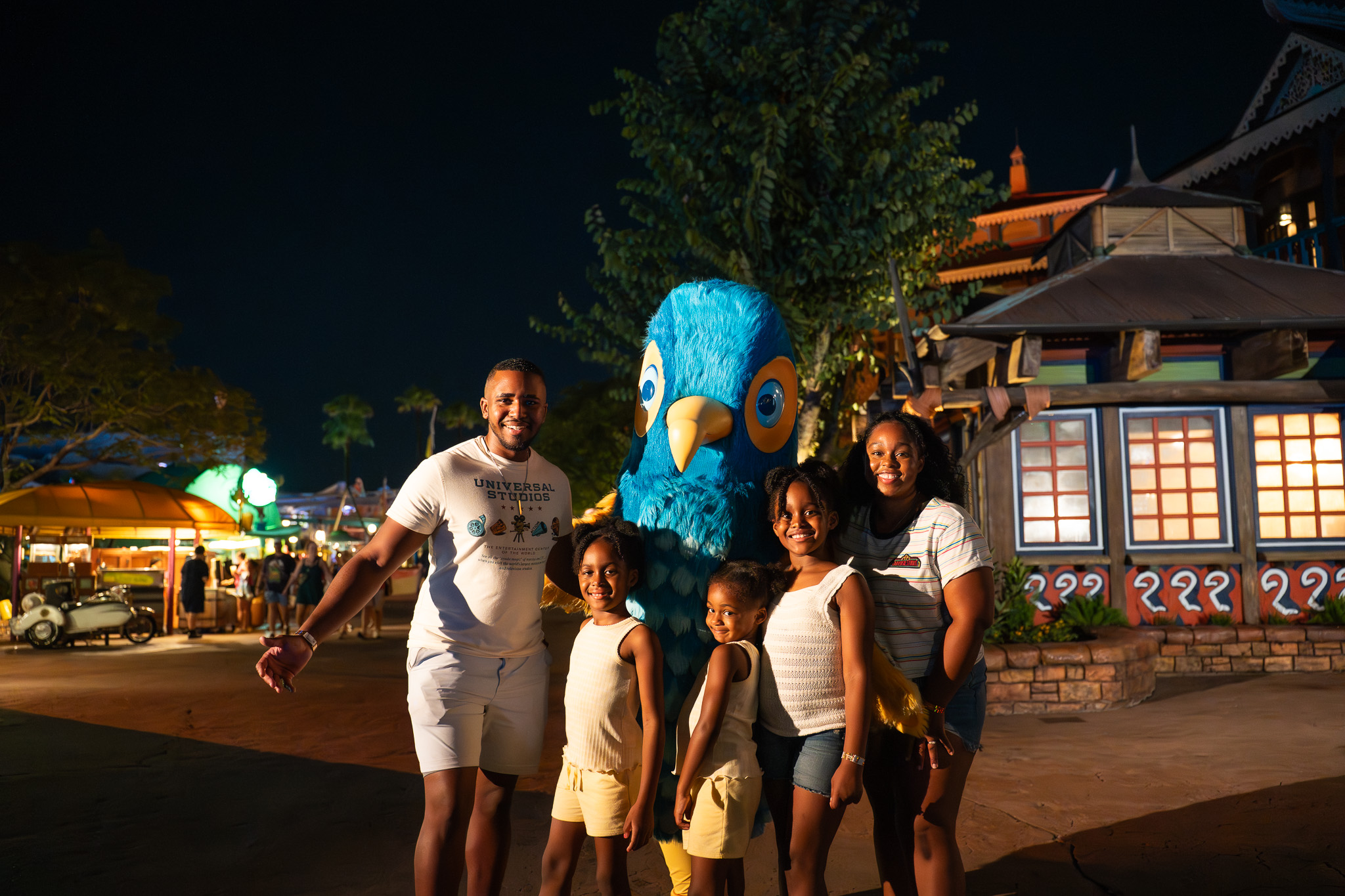 The Roberson family with Churro the Orlando Informer mascot at night